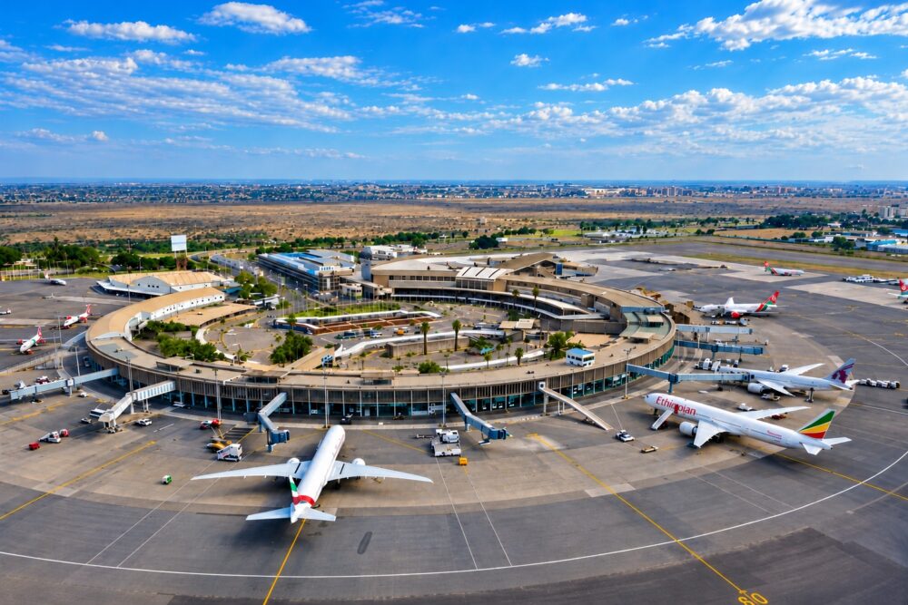 Aerial view of Jomo Kenyatta International Airport (JKIA) in Nairobi, Kenya, showing the airport terminal, parked passenger aircraft and surrounding runways.